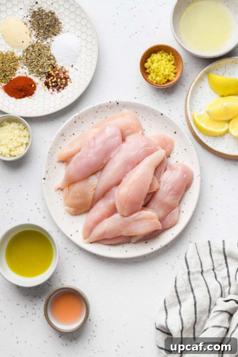 Lemon-Oregano Grilled Chicken Skewers 3 Arrangement of Greek chicken kabob ingredients including chicken, lemon, herbs, and spices