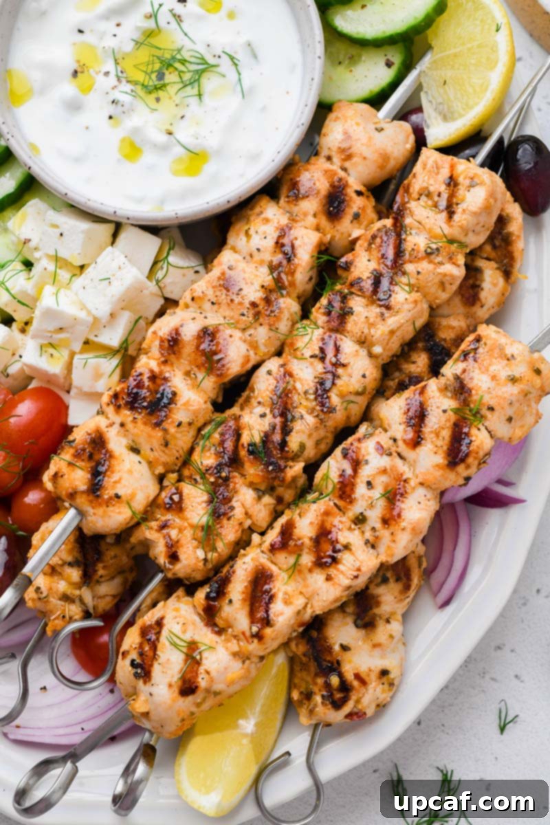 Lemon-Oregano Grilled Chicken Skewers 6 Close-up shot of the perfectly grilled Greek chicken skewers on a serving plate