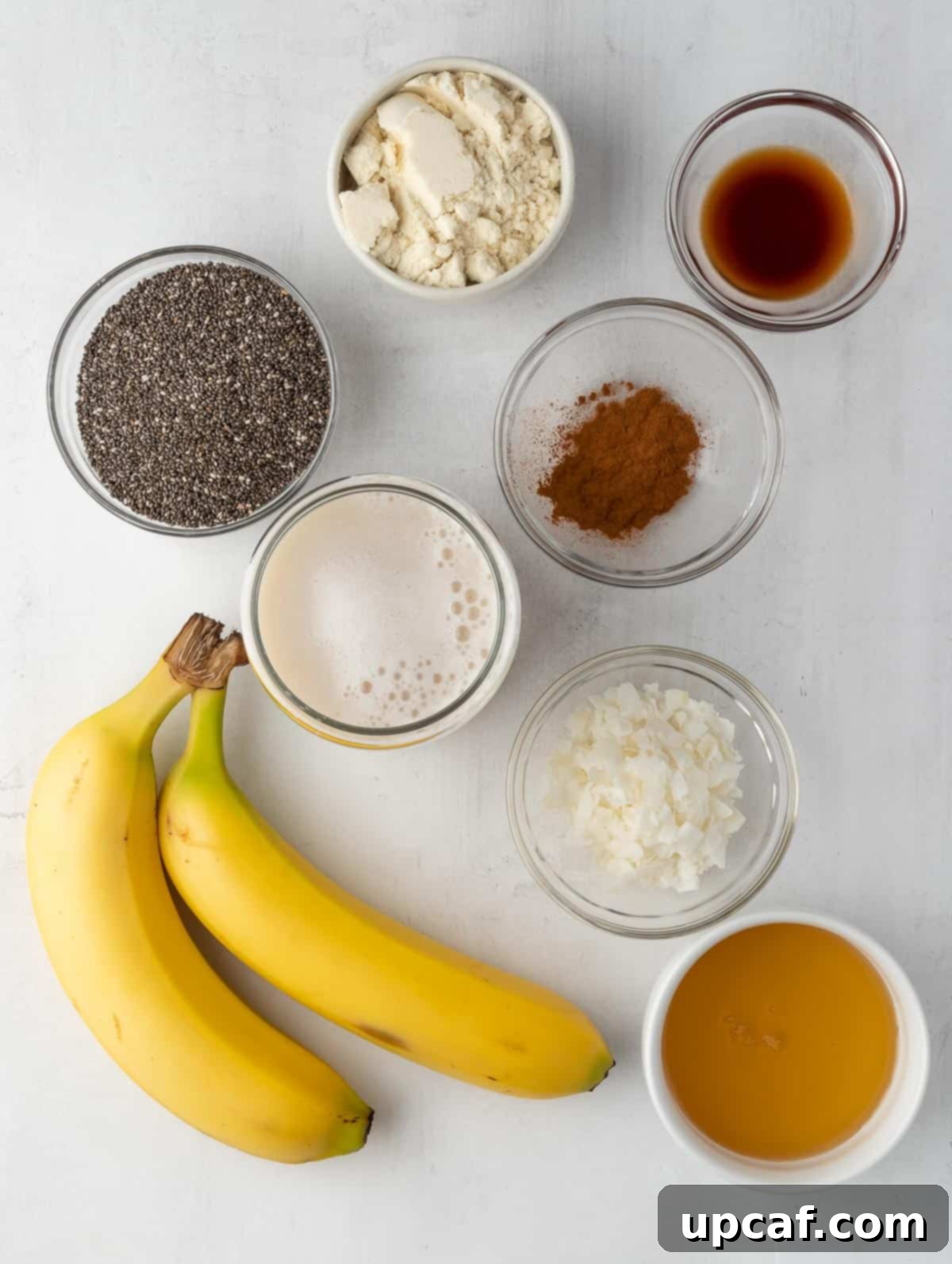 ingredients of the protein banana cream pie pudding laid out on a table, including chia seeds, bananas, and coconut milk