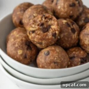 protein bites in a bowl with a bite taken out of one.