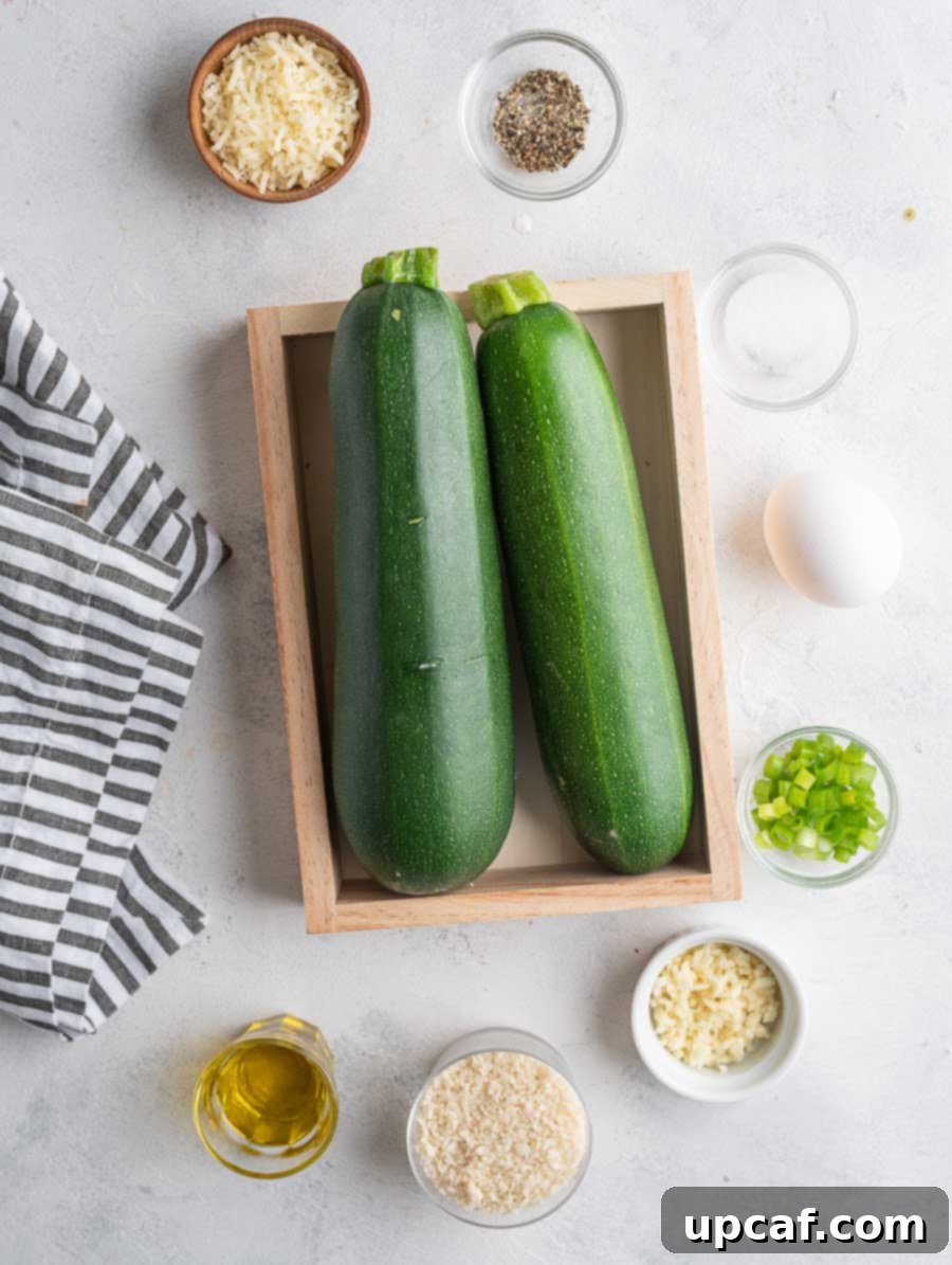 Crispy Zucchini Pancakes 3 All the fresh ingredients for making zucchini fritters, neatly laid out on a kitchen counter.