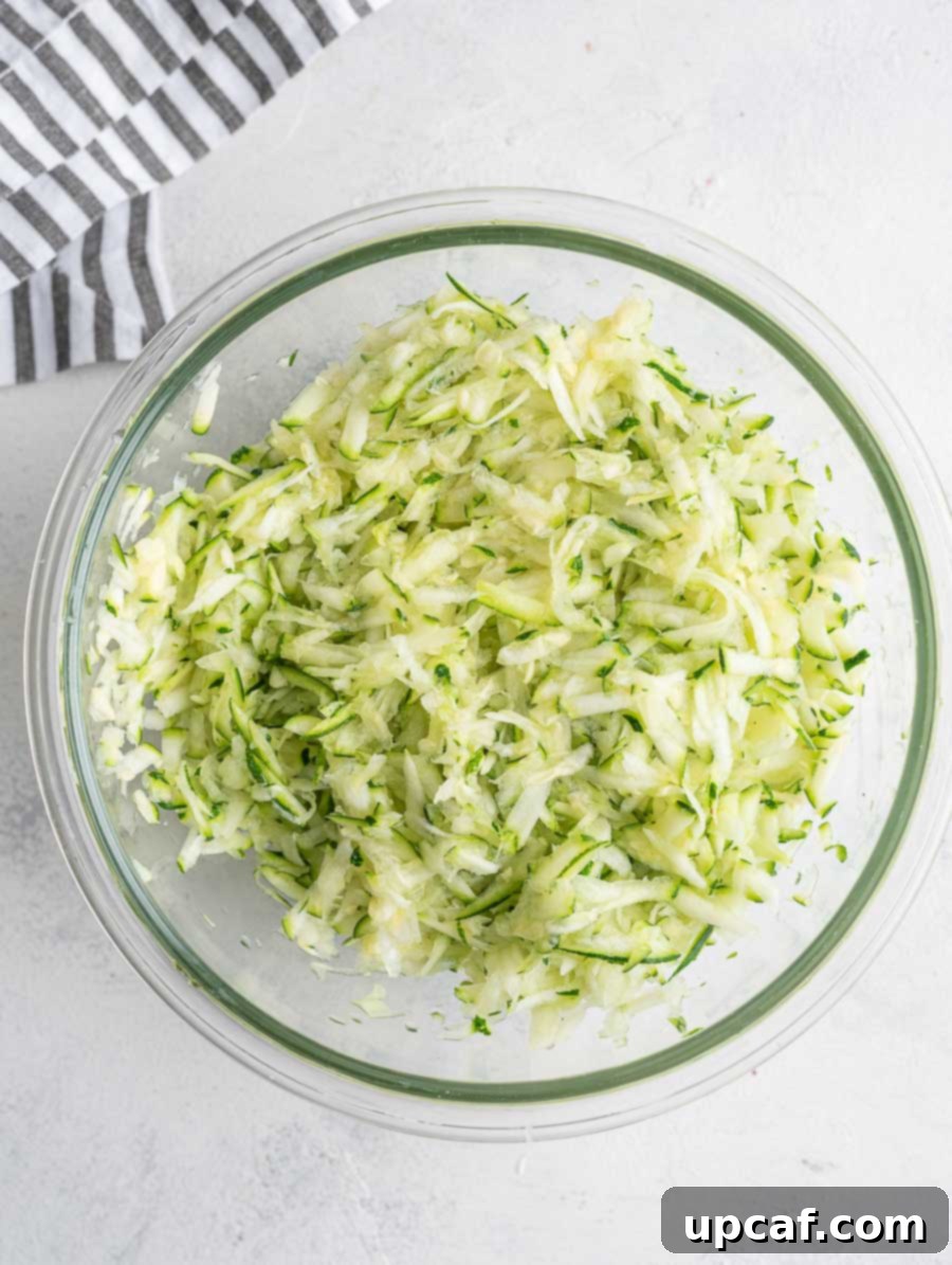 Crispy Zucchini Pancakes 4 A bowl of freshly shredded zucchini, demonstrating the first step in preparing the fritters.