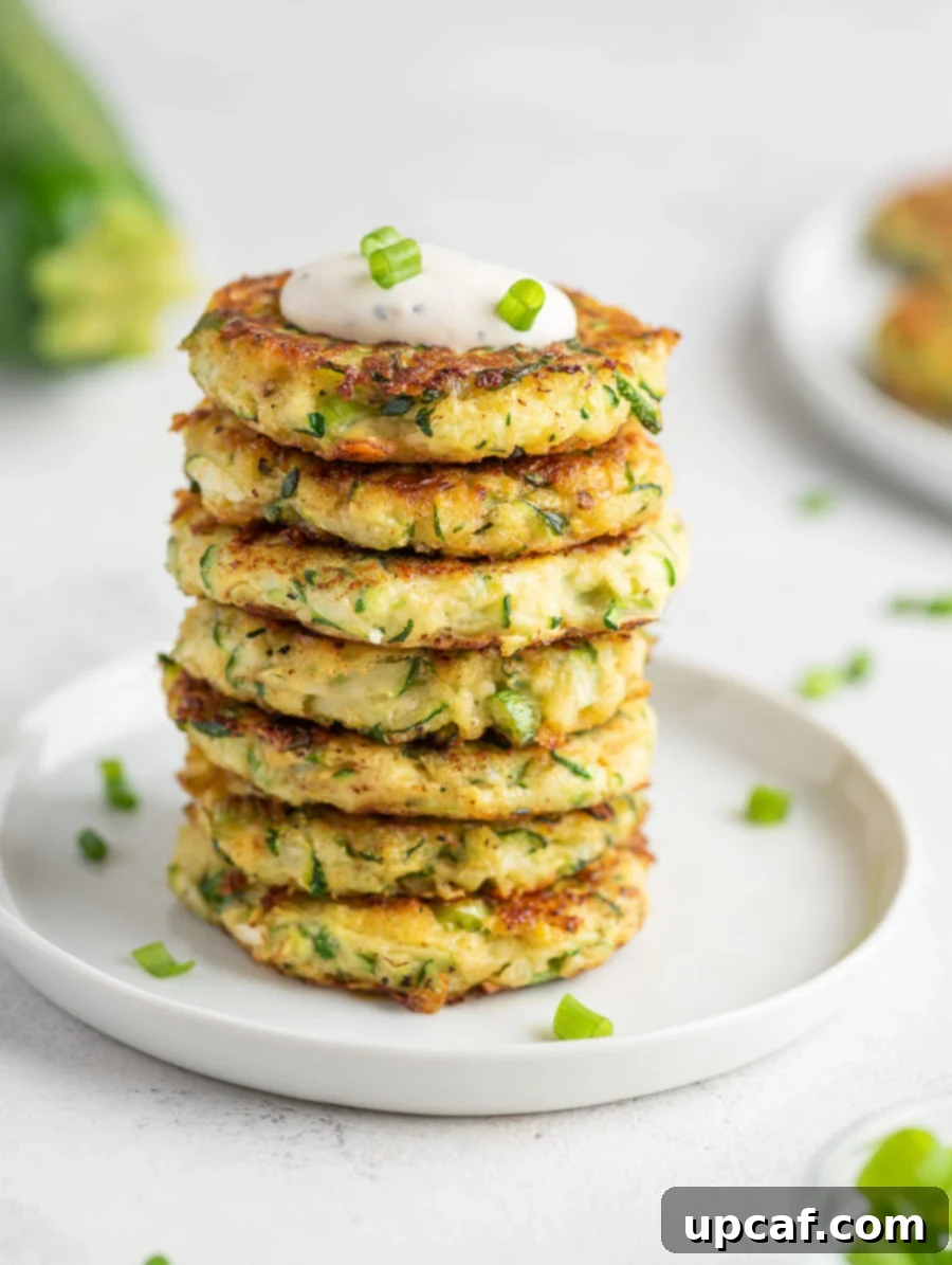 Crispy Zucchini Pancakes 9 A beautifully composed stack of several zucchini fritters, ready to be enjoyed.
