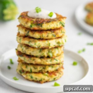 Crispy Zucchini Pancakes 10 A stack of perfectly cooked zucchini fritters, ready to be served and enjoyed.