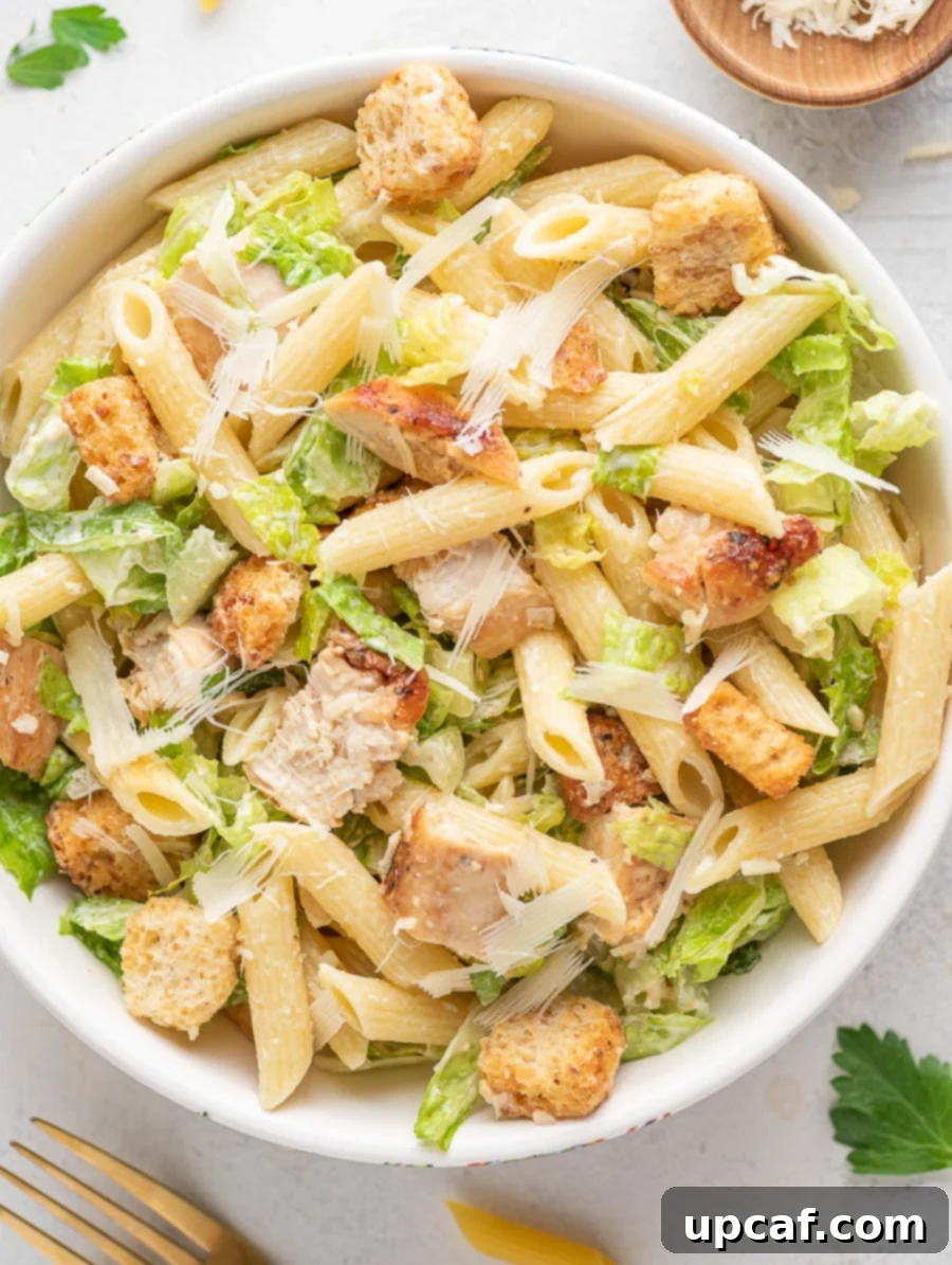 chicken caesar pasta salad in a white bowl