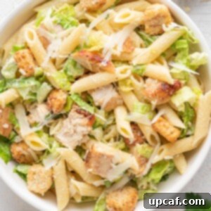 chicken caesar pasta salad in a white bowl