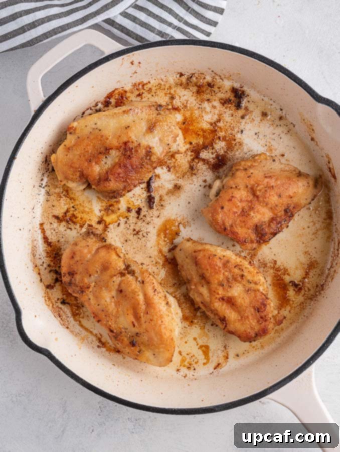 One-Pan Creamy Spinach Artichoke Chicken 5 pan seared chicken in a skillet