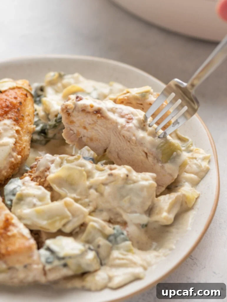 One-Pan Creamy Spinach Artichoke Chicken 9 creamy spinach artichoke cut through to show the center