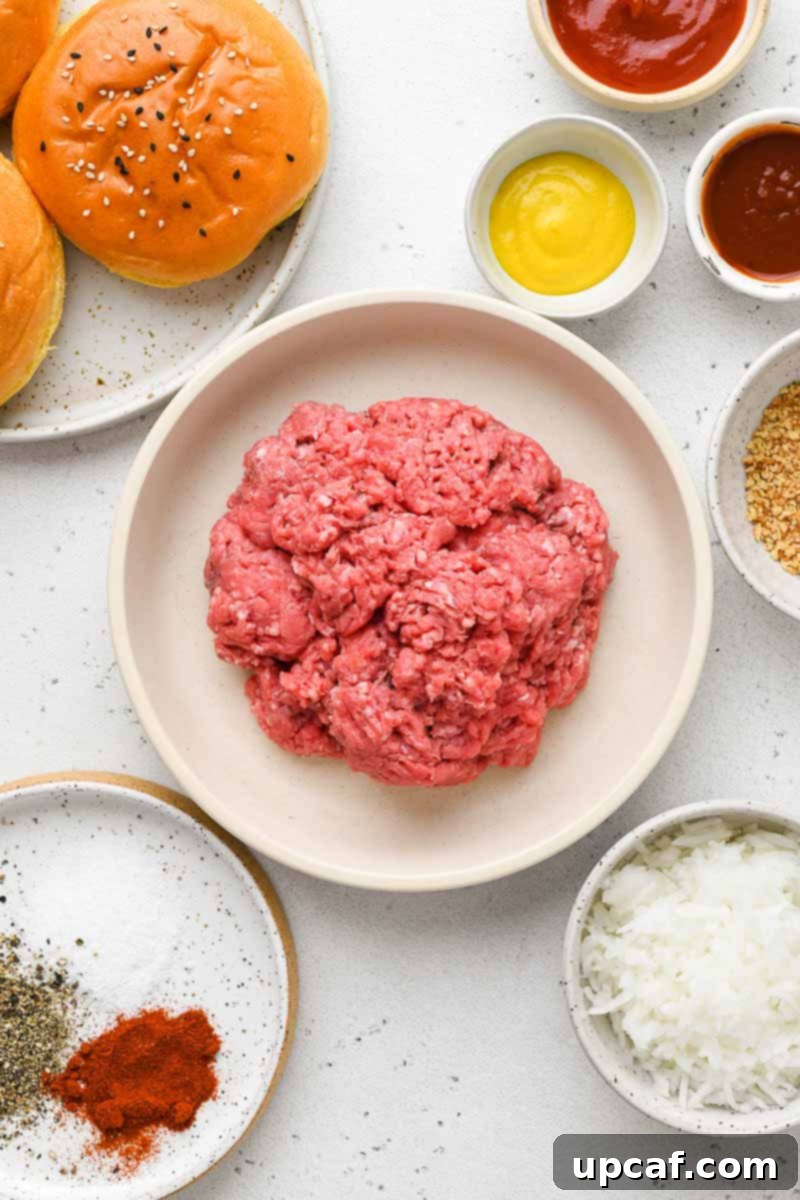 A selection of fresh ingredients laid out on a wooden board, including ground beef, a small onion, bottles of ketchup, mustard, and BBQ sauce, along with various seasonings and breadcrumbs.