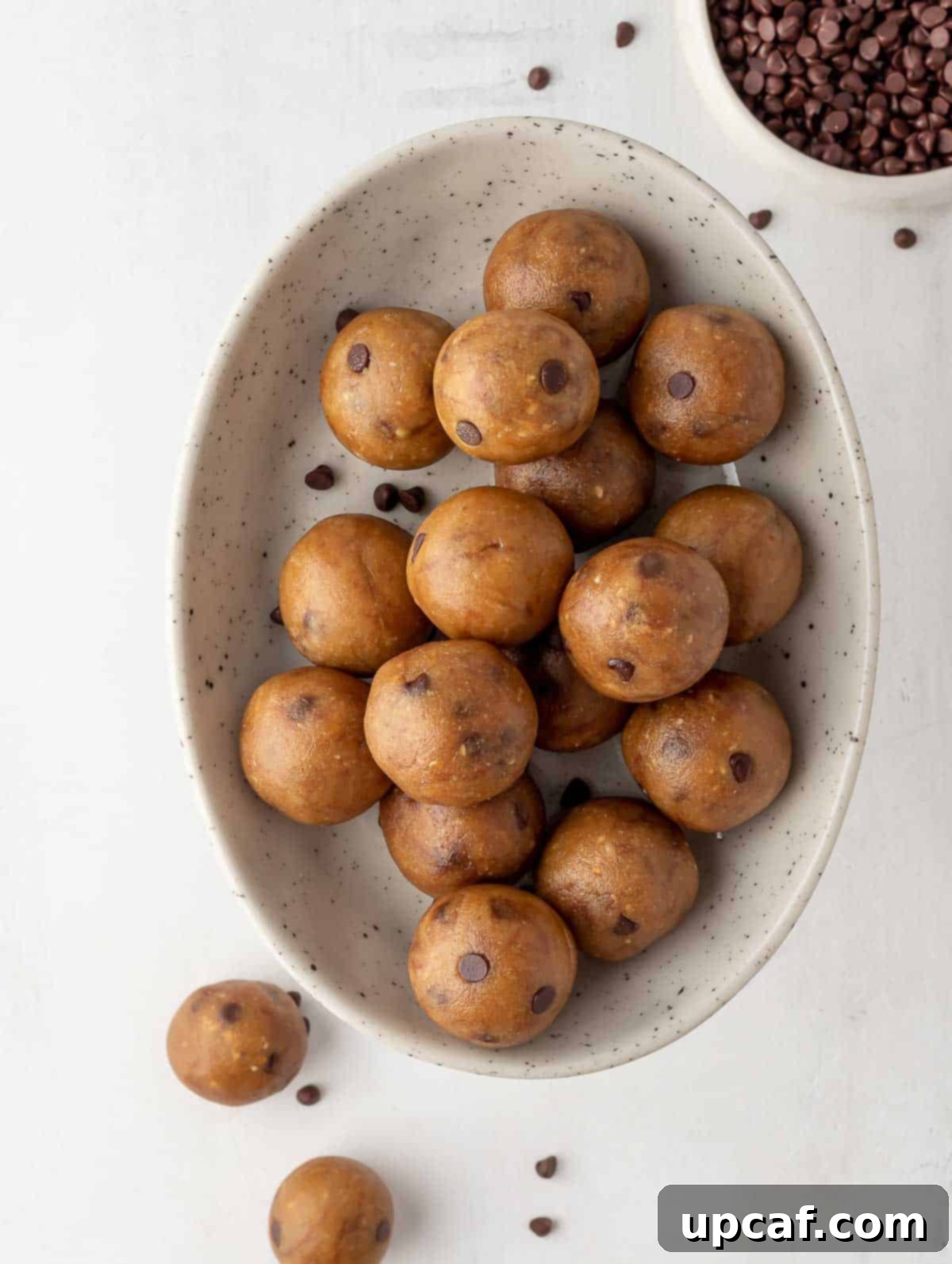 An appealing top-down view of finished cookie dough protein balls served in a white bowl, ready to be enjoyed.