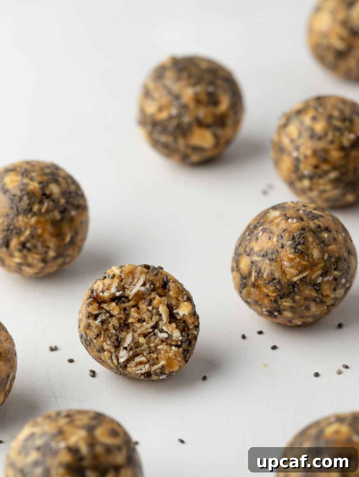 Vanilla Protein Power Bites 9 Close-up shot of one vanilla protein energy ball with a bite taken out, revealing its soft interior