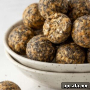 Vanilla Protein Power Bites 10 Close-up shot of a vanilla protein energy ball, halved, in a white bowl