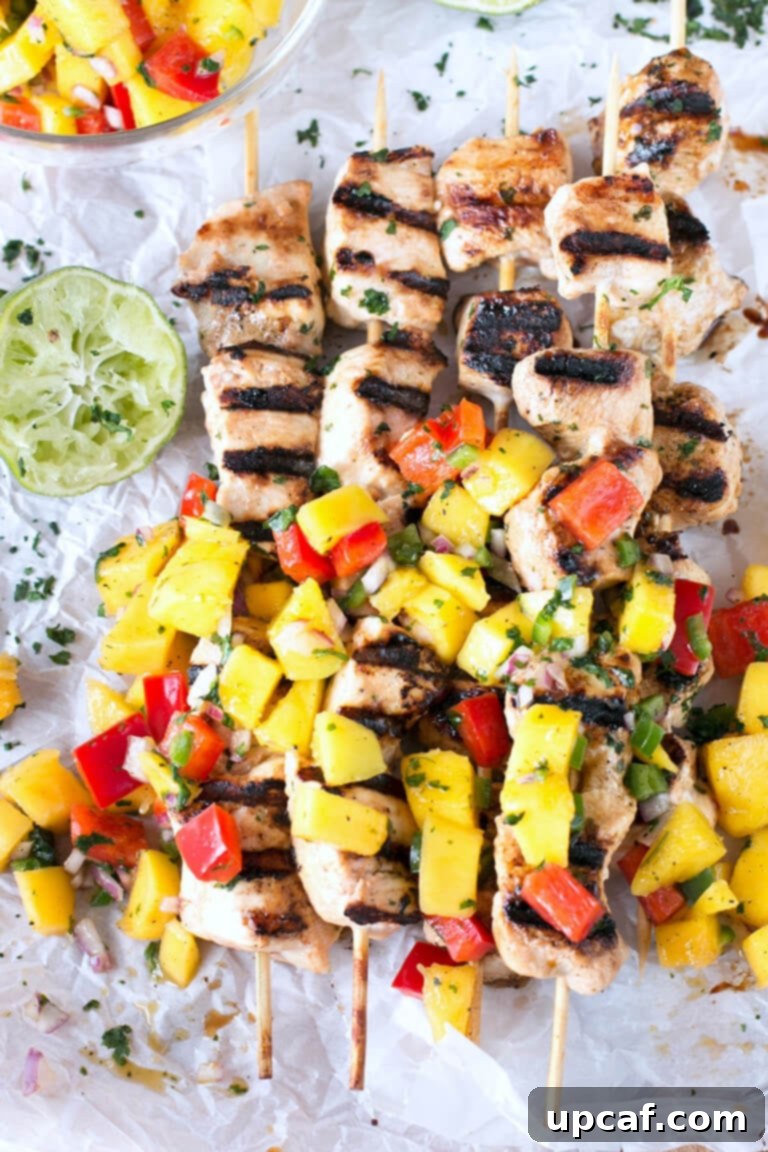 Easy Grilled Mango Chicken Skewers with a fresh mango and pepper salsa are deliciously juicy and packed with flavor. These are great for dinner!