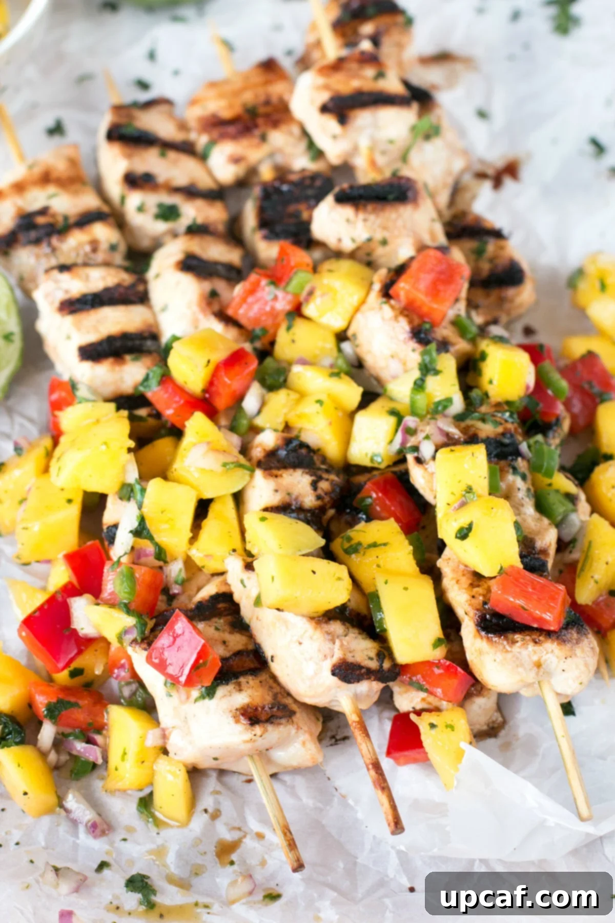 Stacked mango chicken skewers with mango and bell pepper salsa