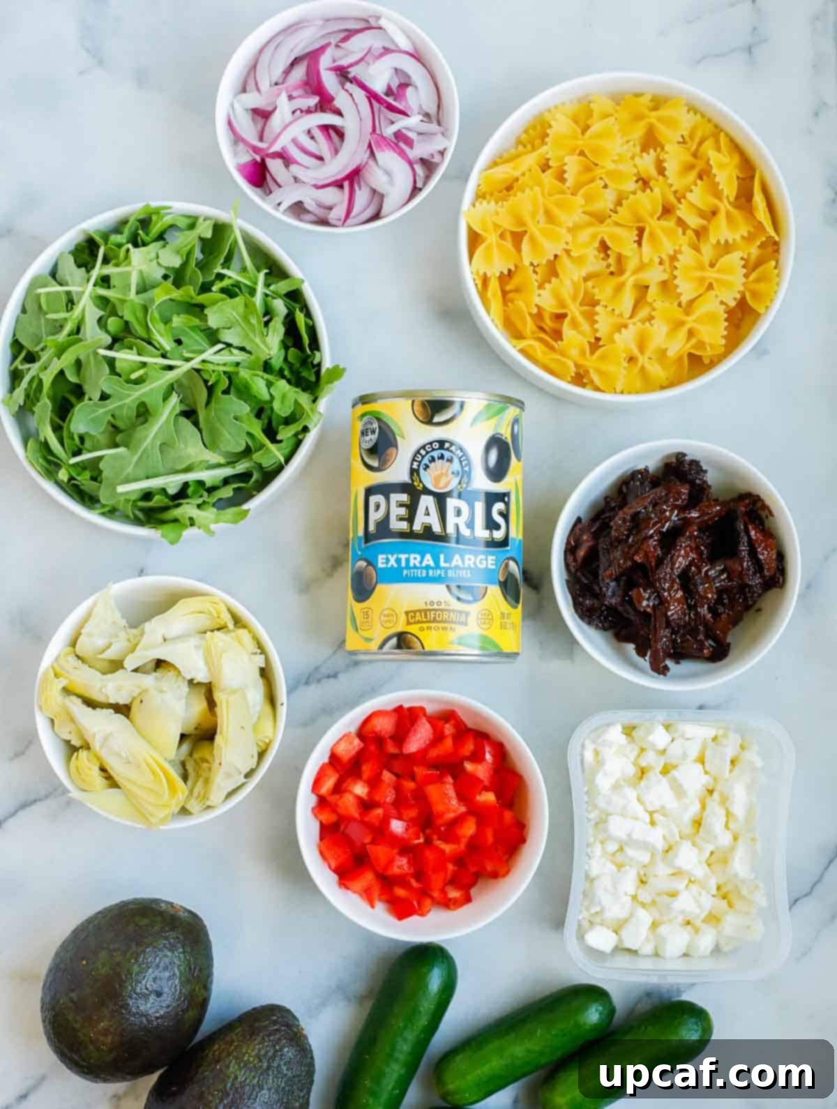 Assortment of fresh and colorful ingredients laid out beautifully for making Lemon Herb Mediterranean Pasta Salad.