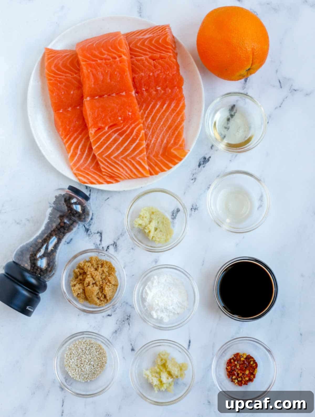 Sweet & Sticky Teriyaki Salmon 3 A selection of fresh ingredients including salmon fillets, oranges, ginger, garlic, and soy sauce, ready for making baked teriyaki salmon.