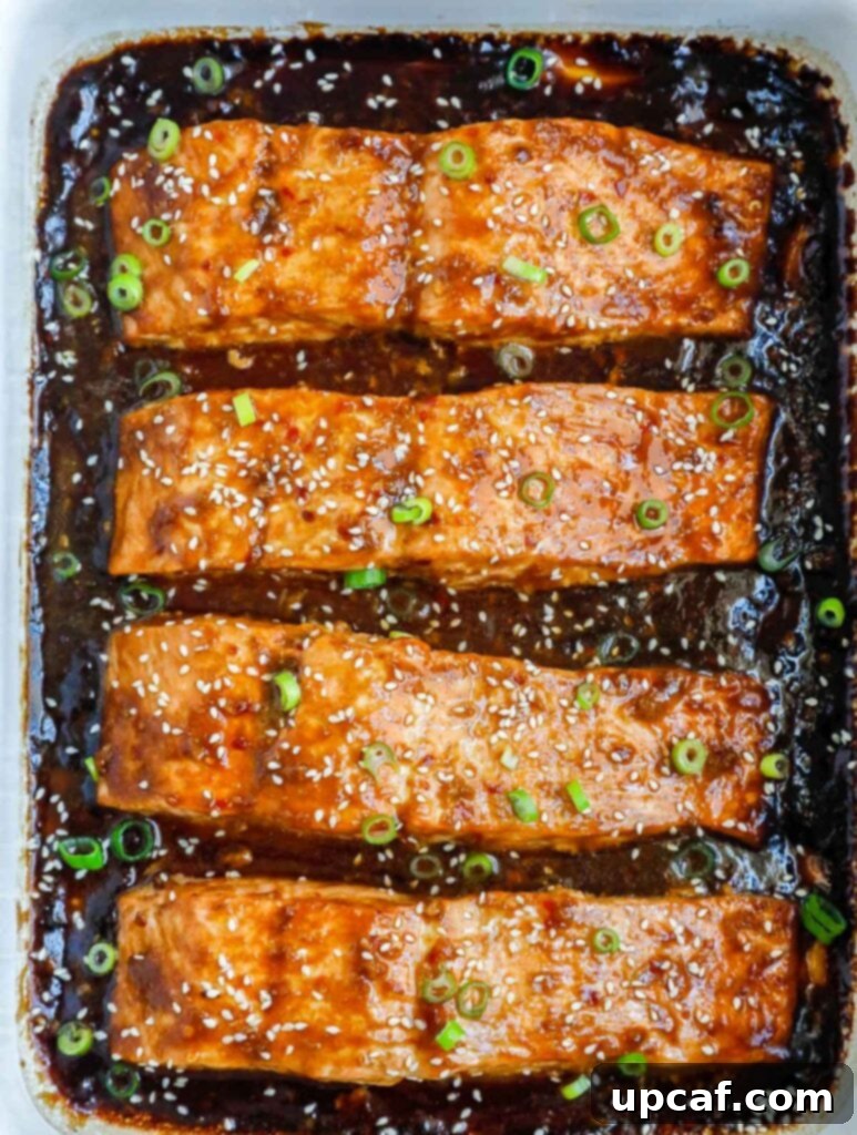 Sweet & Sticky Teriyaki Salmon 6 A perfectly baked teriyaki salmon fillet in a dish, ready to be served.