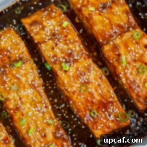 Sweet & Sticky Teriyaki Salmon 8 Baked teriyaki salmon in a baking dish.