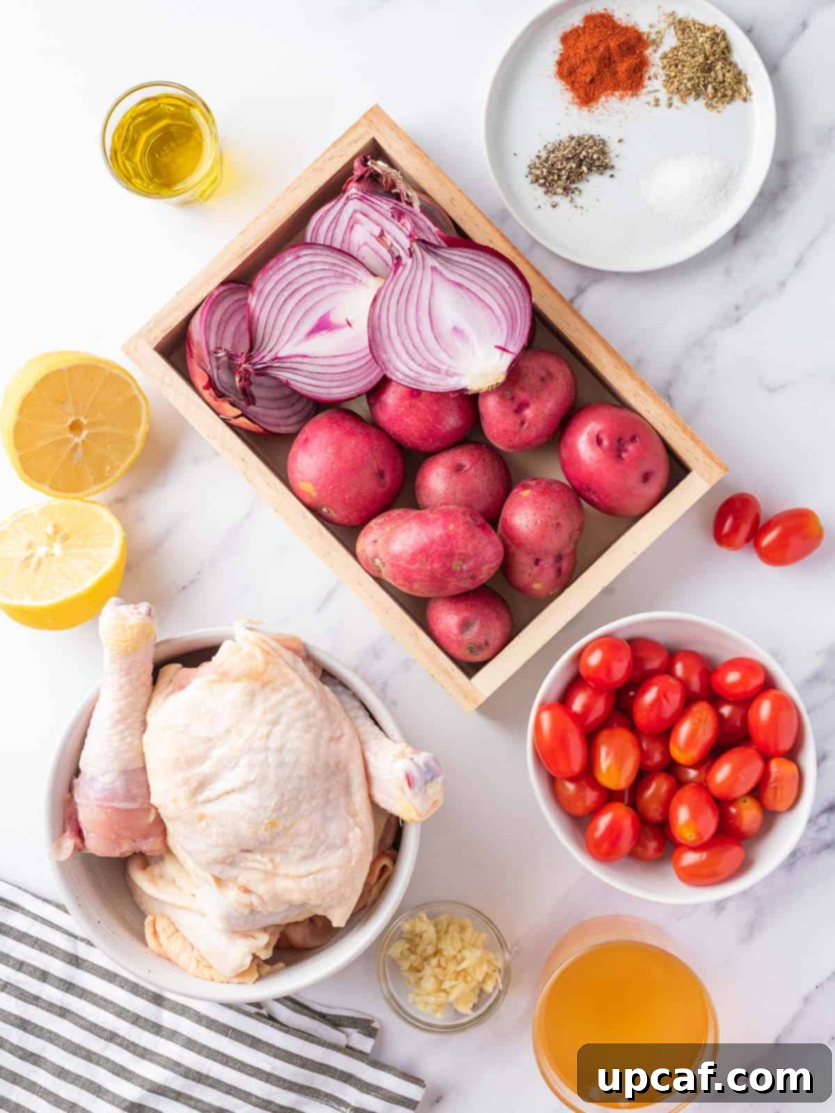 Vibrant Lemon Herb Mediterranean Chicken 3 Assortment of fresh ingredients for Mediterranean Chicken recipe including chicken, vegetables, and herbs