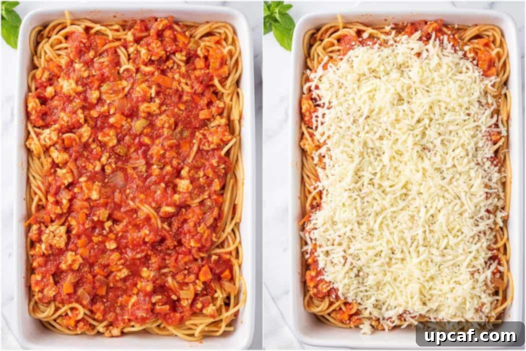 Spaghetti expertly arranged in a baking dish, generously topped with sauce and mozzarella cheese, ready for baking.