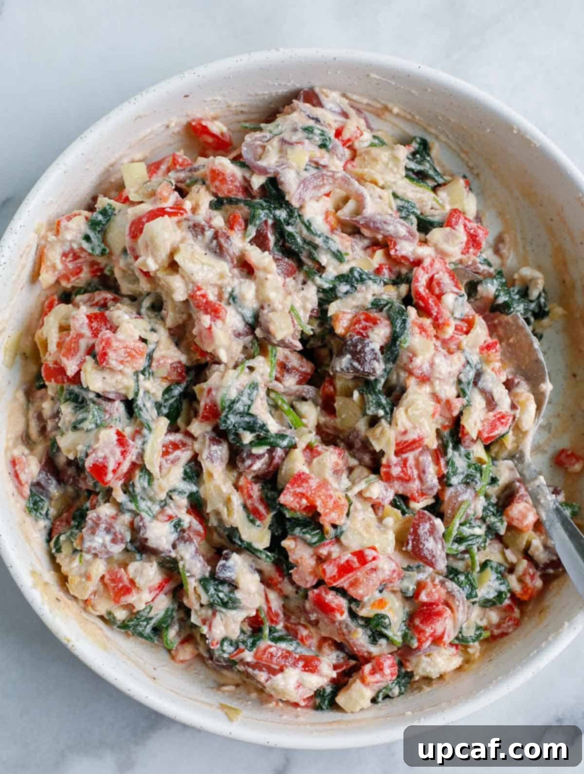 stuffing of the Greek White Alfredo Lasagna in a white bowl.