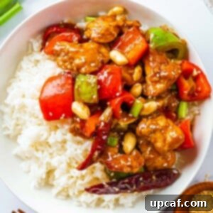 Original Sichuan Kung Pao 11 A bowl of kung pao chicken with rice.