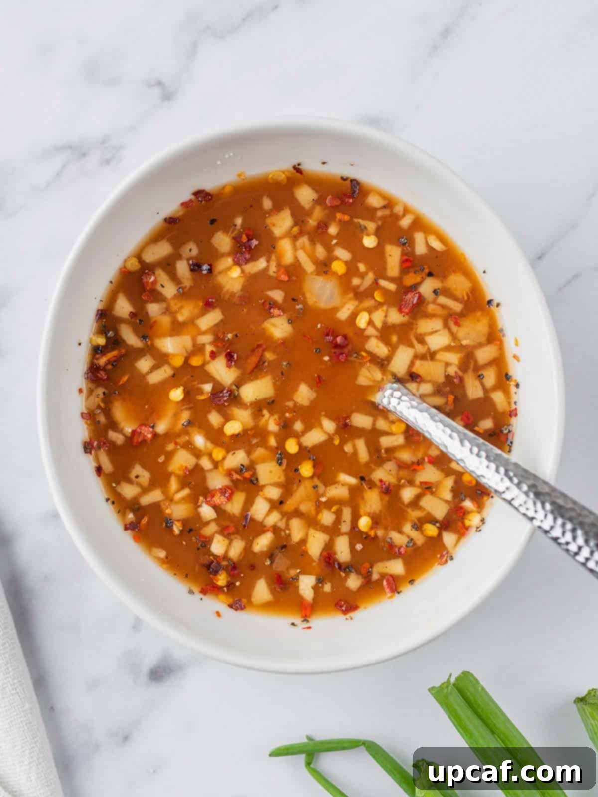 Szechuan chicken sauce in a bowl, ready to be added to the stir-fry.