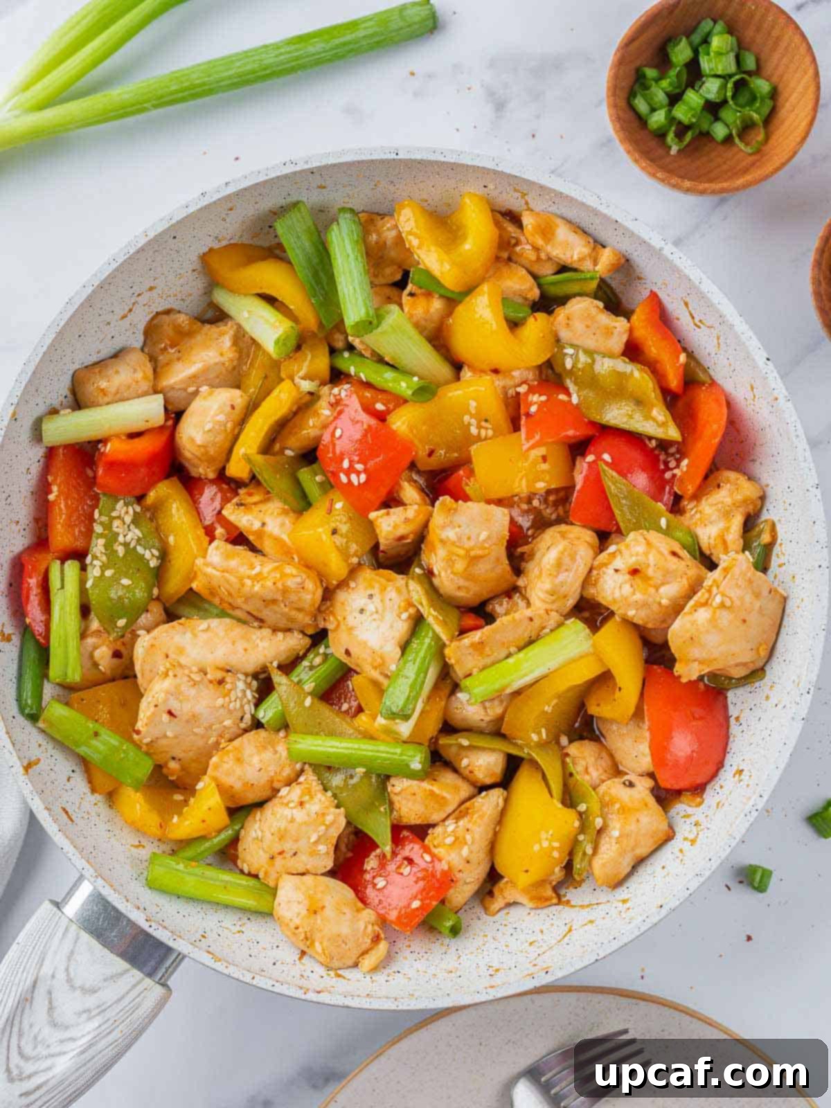 A pan filled with a delicious, saucy Szechuan chicken stir-fry.