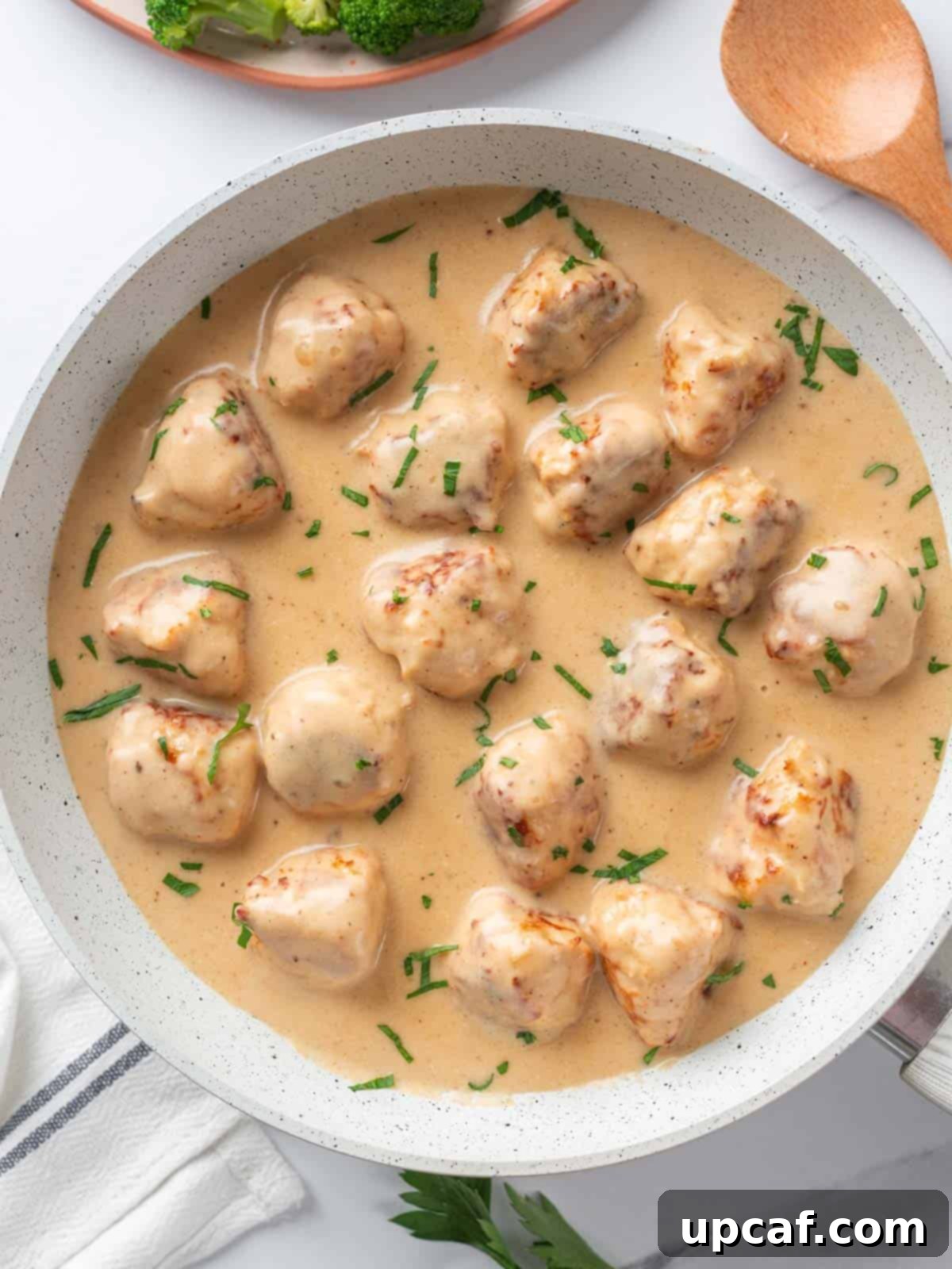 A pan of delicious Swedish Chicken Meatballs coated in creamy gravy.
