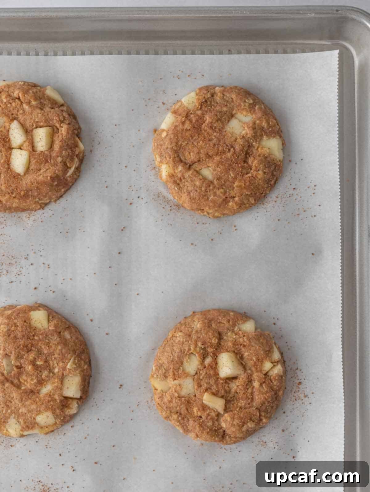 Cozy Apple Pie Cinnamon Oat Cookies 6 A sheet pan with unbaked healthy apple pie oatmeal cookies, shaped and ready for the oven.