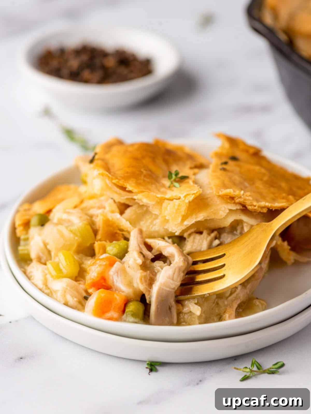 fork poking into the chicken from the pot pie