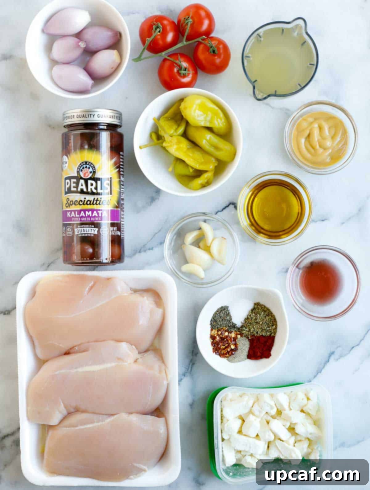 Sheet Pan Mediterranean Chicken Bake 3 Ingredients needed to make oven baked Greek chicken, laid out on a surface.