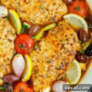 Sheet Pan Mediterranean Chicken Bake 10 Close up of a pan of oven baked Greek chicken breasts.