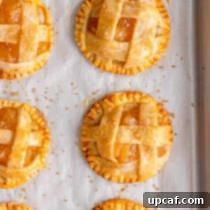 close up shot of the baked mini apple pie on a sheet pan