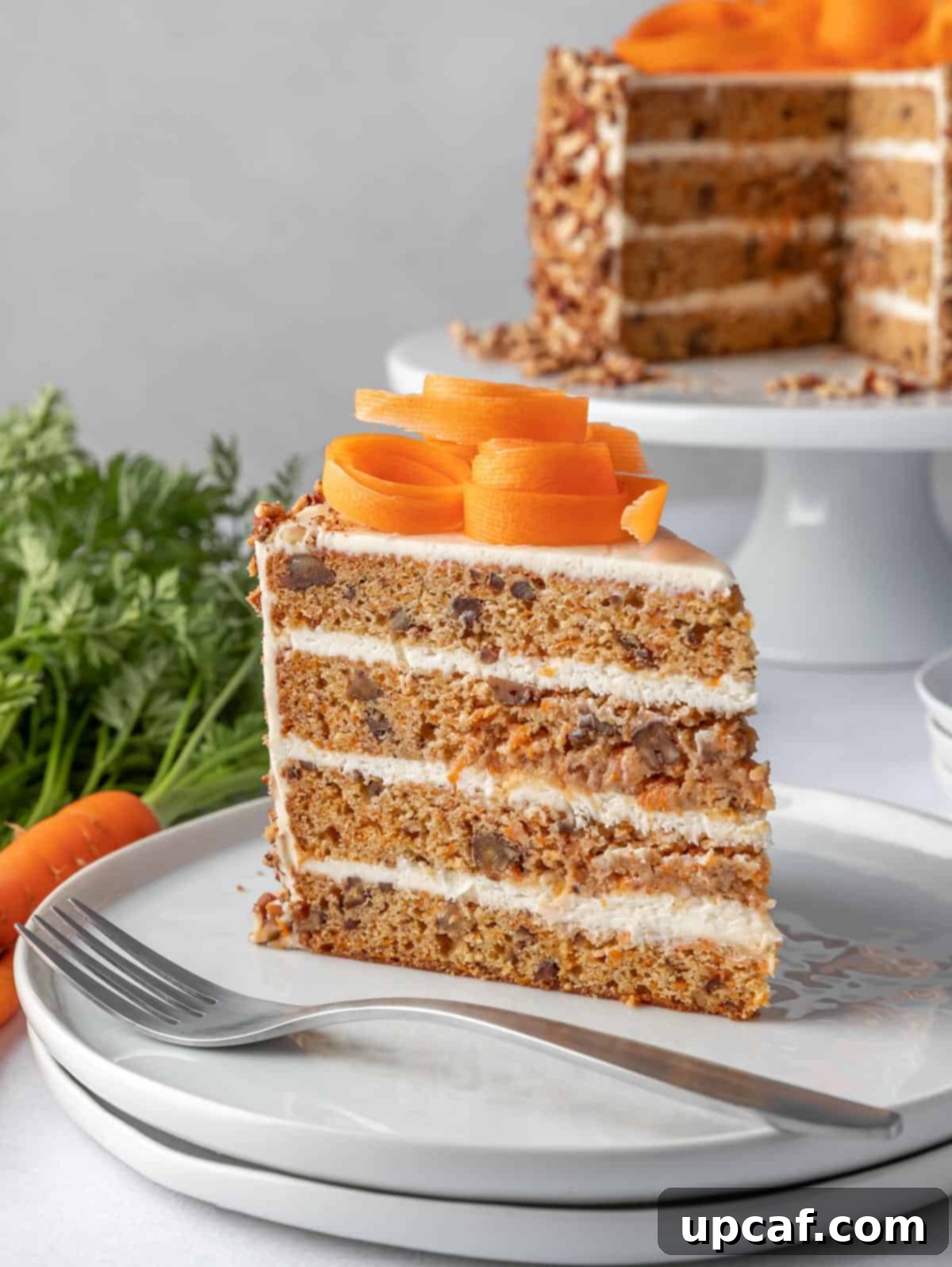slice of carrot cake on a plate with a fork