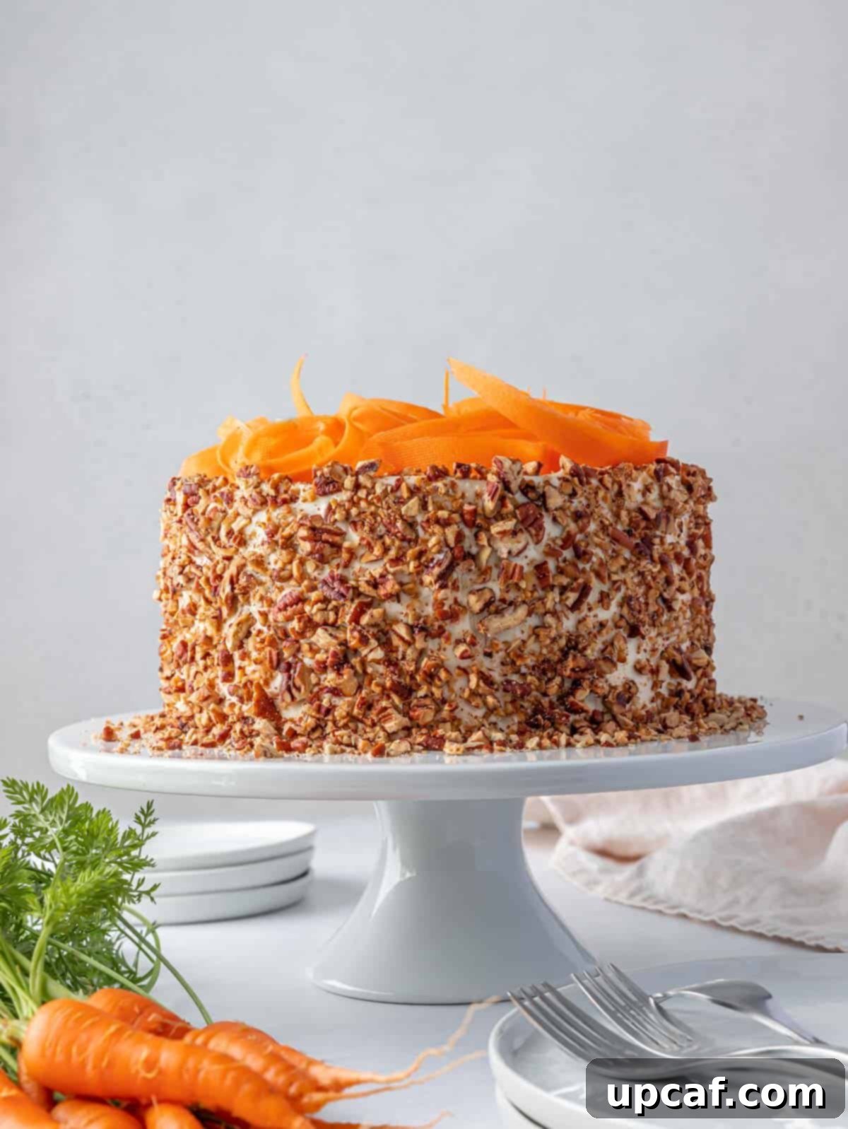 whole decorated carrot cake on a cake stand