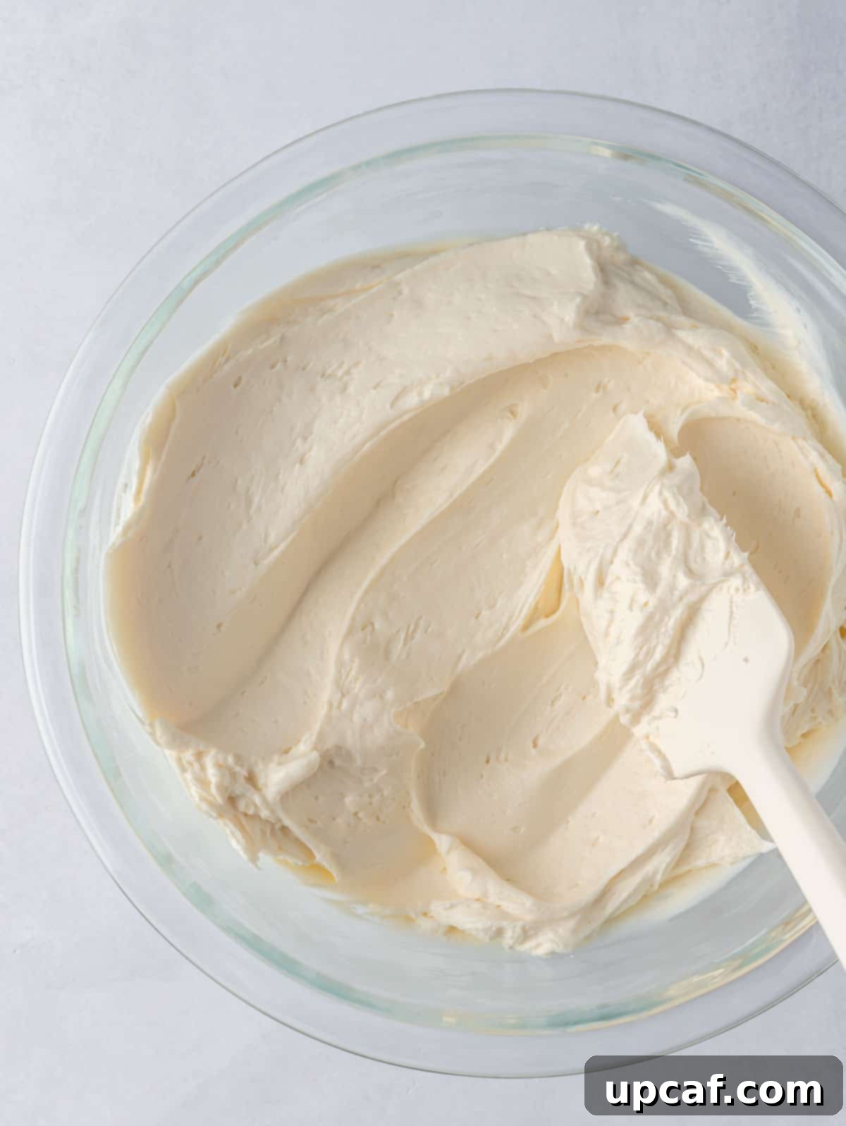 carrot cake frosting in a bowl with a spatula