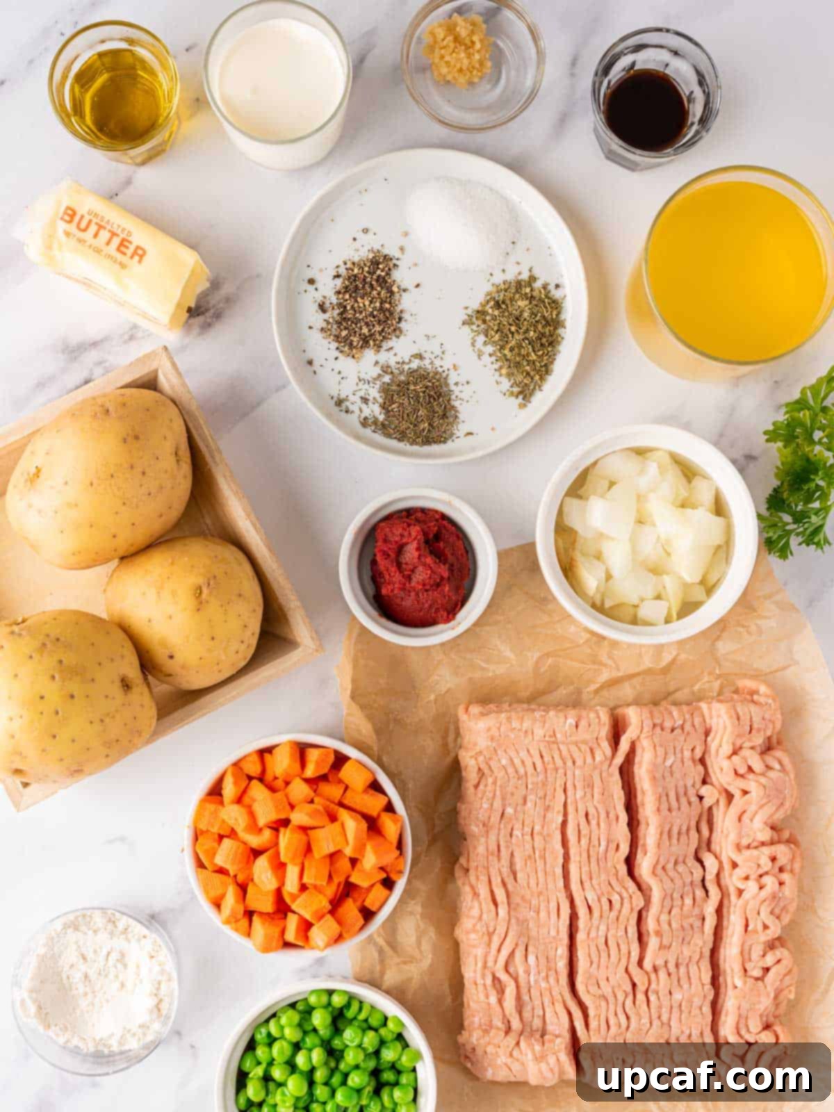 A visual display of all the fresh and measured ingredients needed to make Chicken Shepherd's Pie.