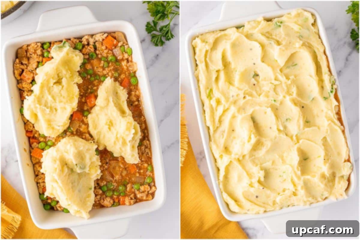 Assembling a shepherd's pie by spreading mashed potatoes evenly over the chicken filling in a rectangular baking dish.