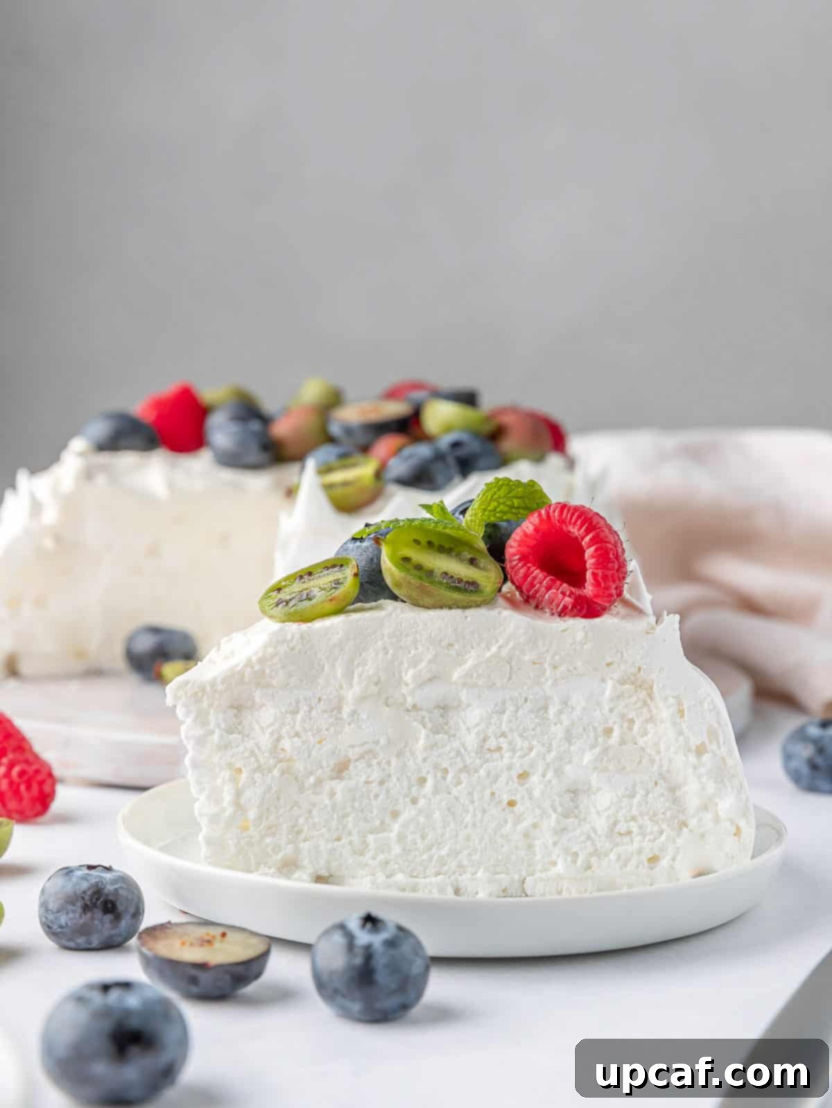 slice of berry pavlova cake on a white plate