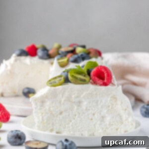 slice of berry pavlova cake on a white plate