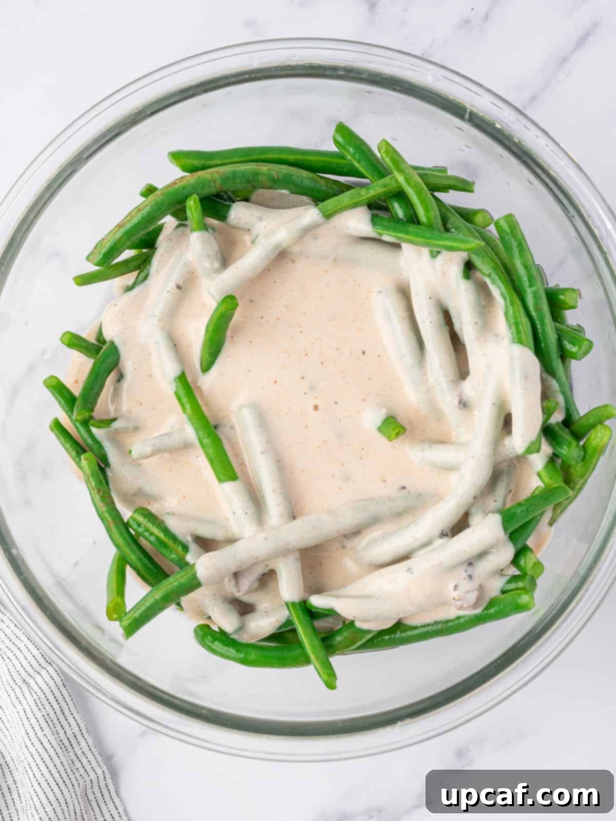 creamy sauce in blanched green beans