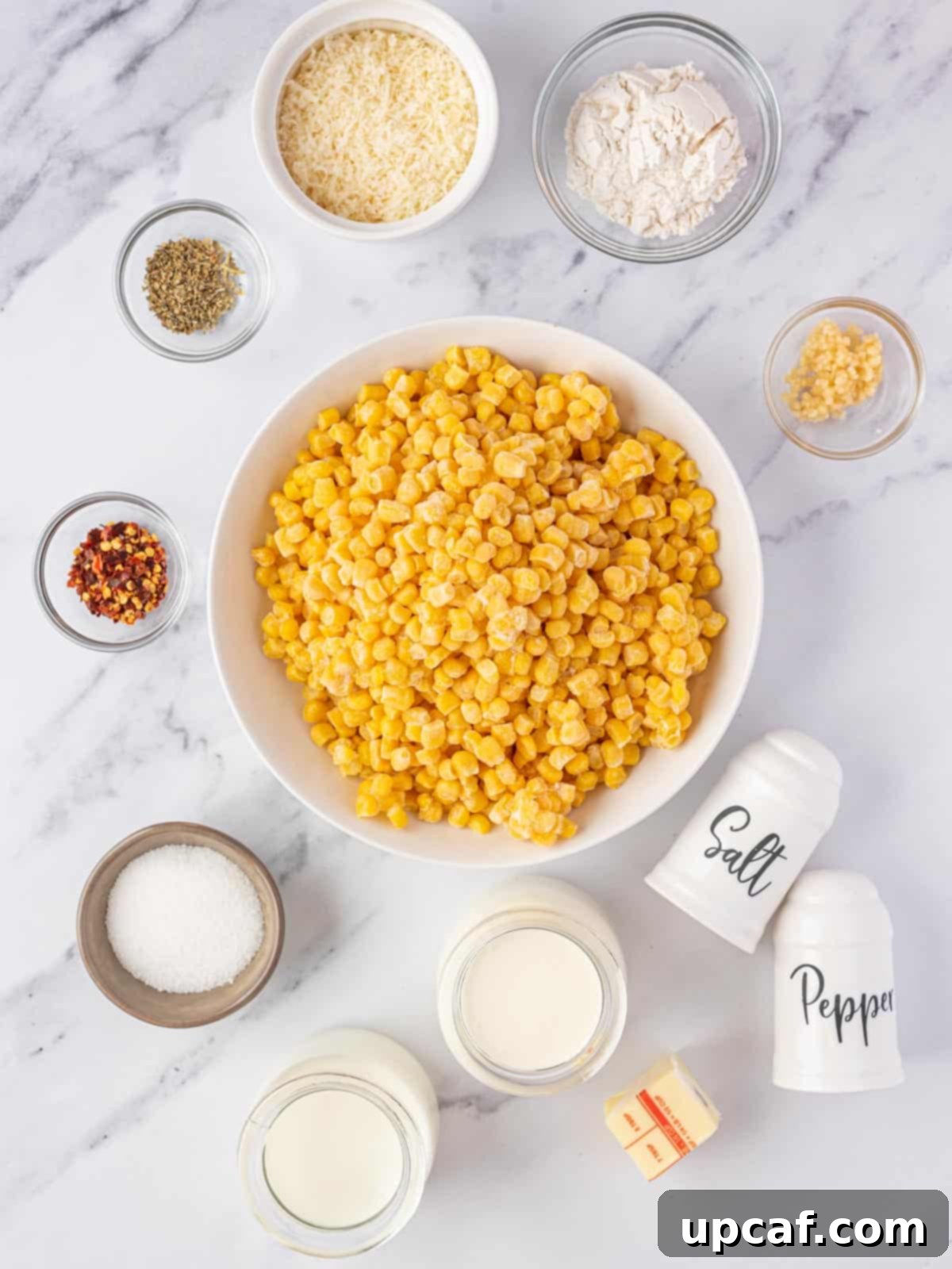 ingredients of creamed corn casserole displayed on a wooden board