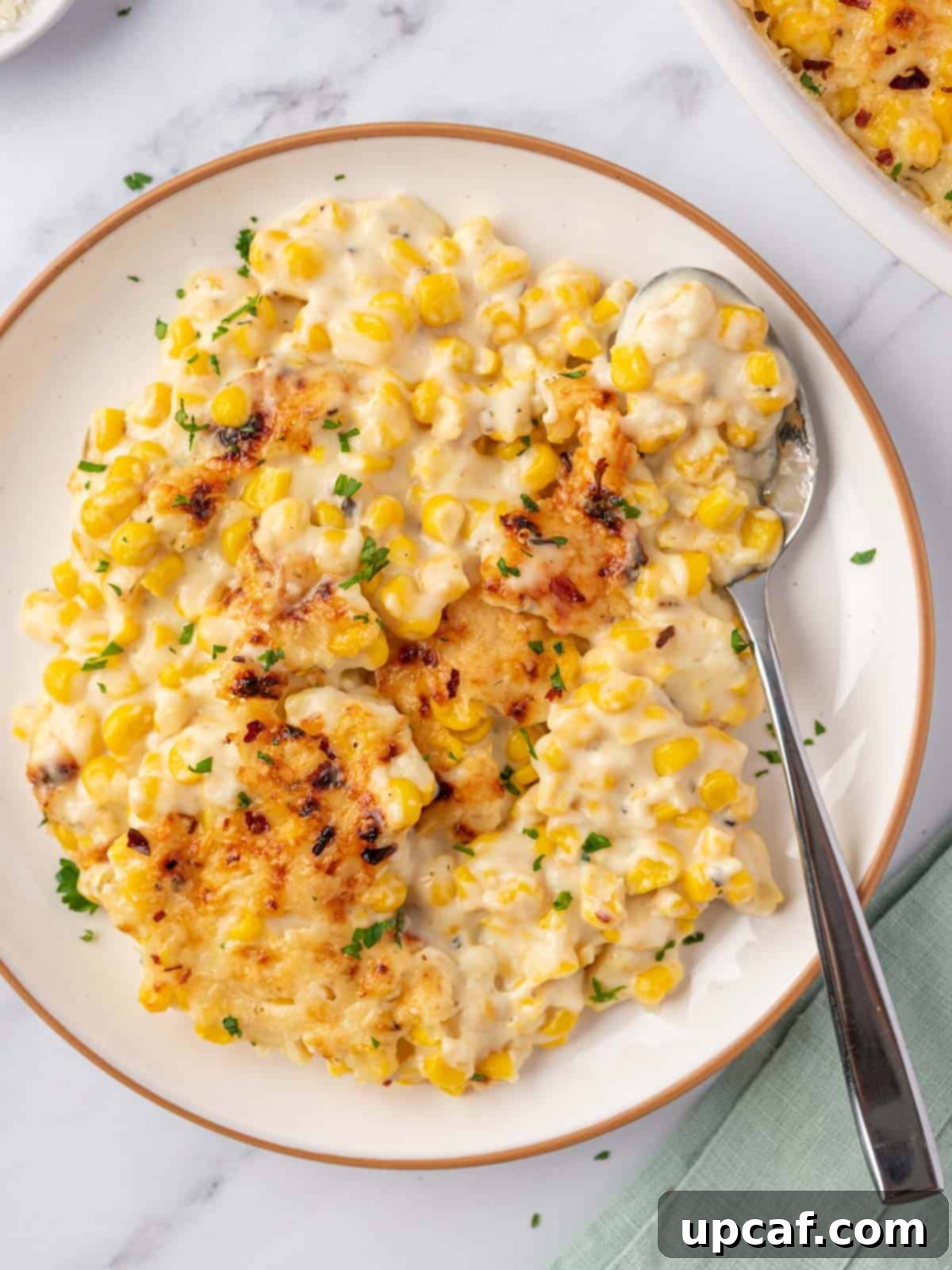 creamed corn casserole in a plate, showing its creamy texture