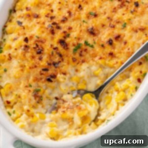 creamed corn casserole with a spoon scooping out some corn