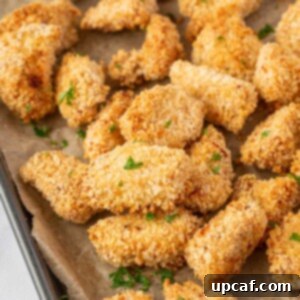 Crispy popcorn chicken on a baking sheet.