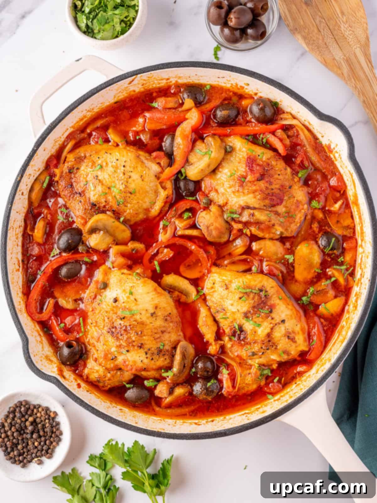 The best chicken cacciatore with chicken thighs, red peppers and olives. A rich, savory one-pan Italian stew.