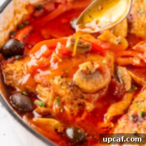 Close up photo of easy chicken cacciatore in a skillet. A hearty and savory Italian chicken stew.
