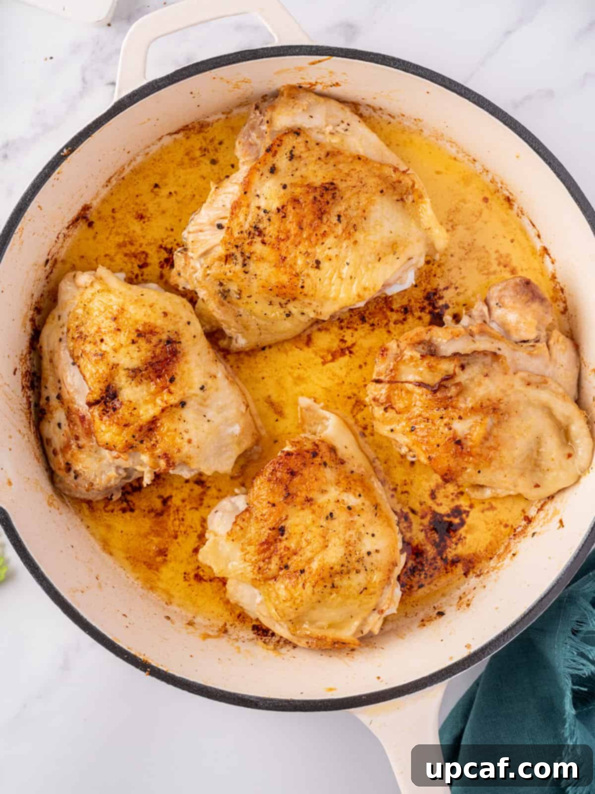 Chicken browning beautifully in a skillet, creating a rich crust.