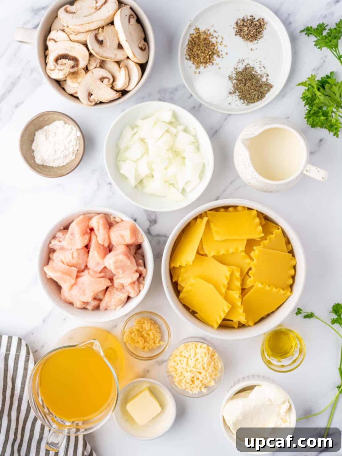 Creamy Chicken Lasagna Soup 3 Ingredients needed for creamy white chicken lasagna soup, laid out on a kitchen counter.